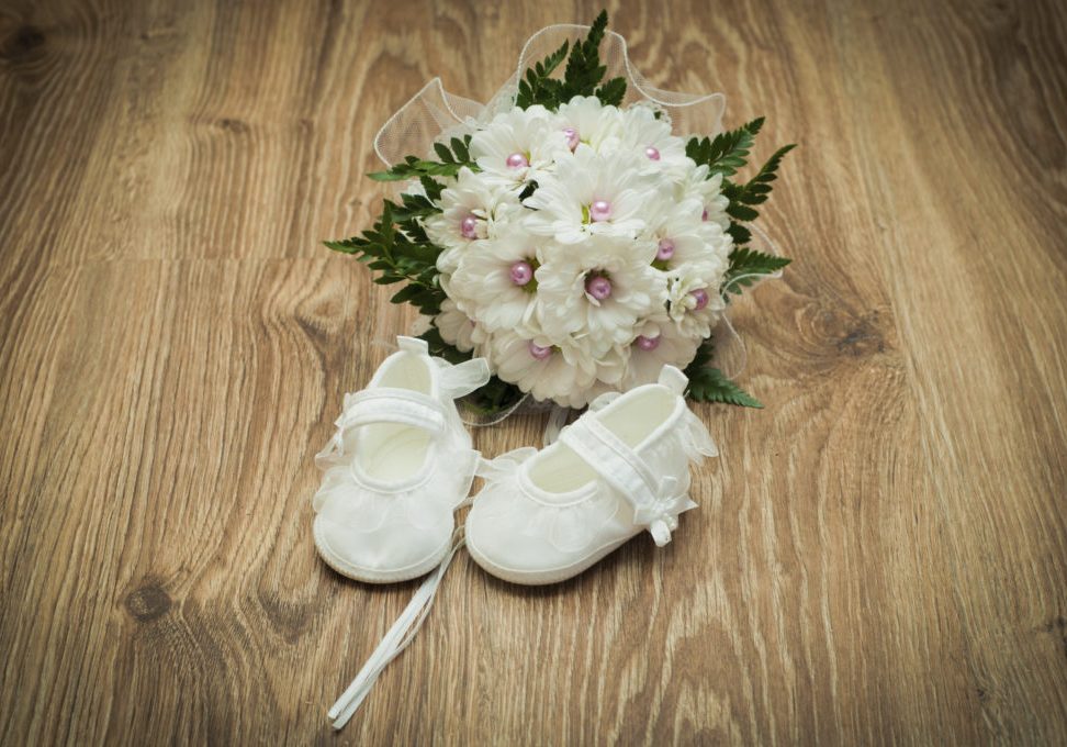 white shoes and white bouquet on a wooden floor